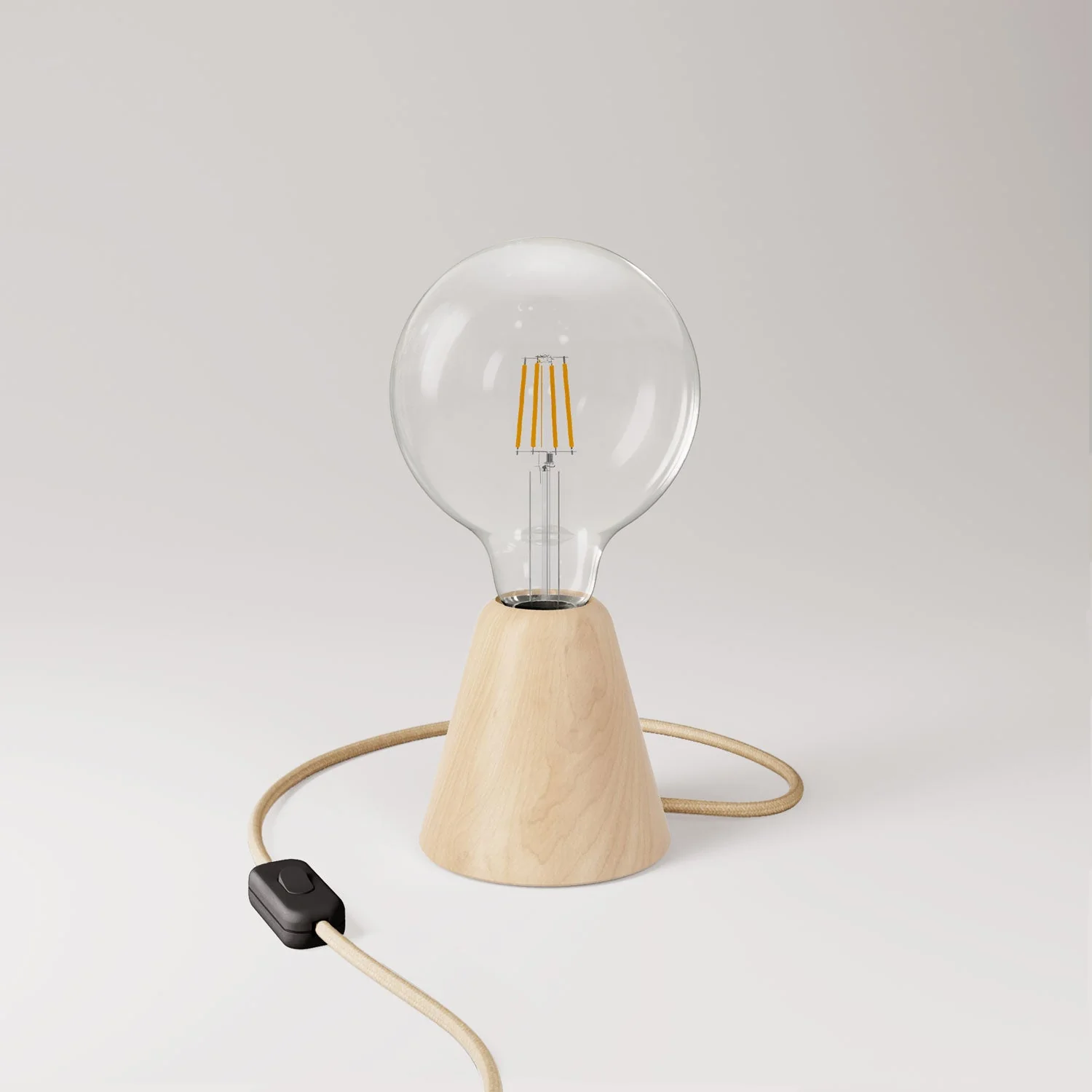 Table lamp with alder wood base, transparent light bulb, RN06 cable and UK plug.